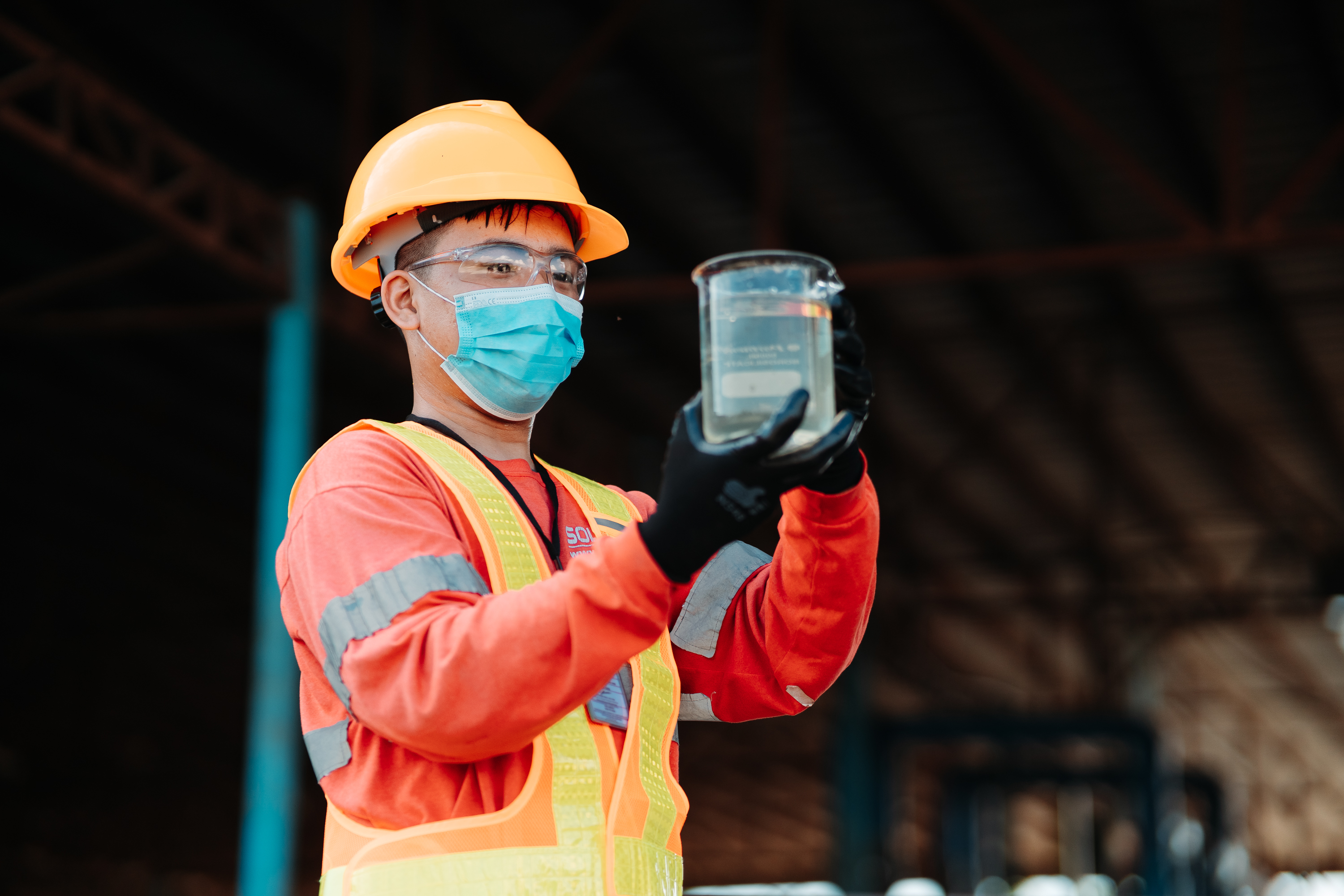 SEMC Worker inspecting sample